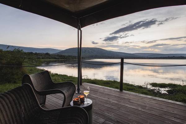 View over Lake Rwanyakazinga from luxury tented room veranda with deck chairs