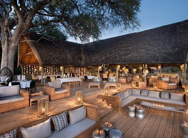 Sable Alley thatched dining area with outdoor loungers and couches