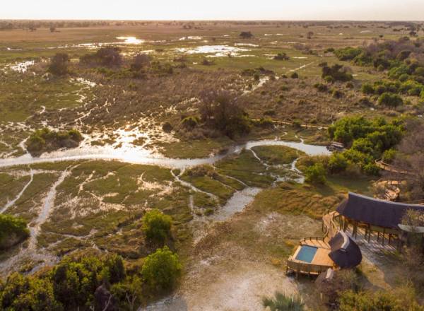 Aerial view of Okavango Delta and chalets and pool of Camp Okavango