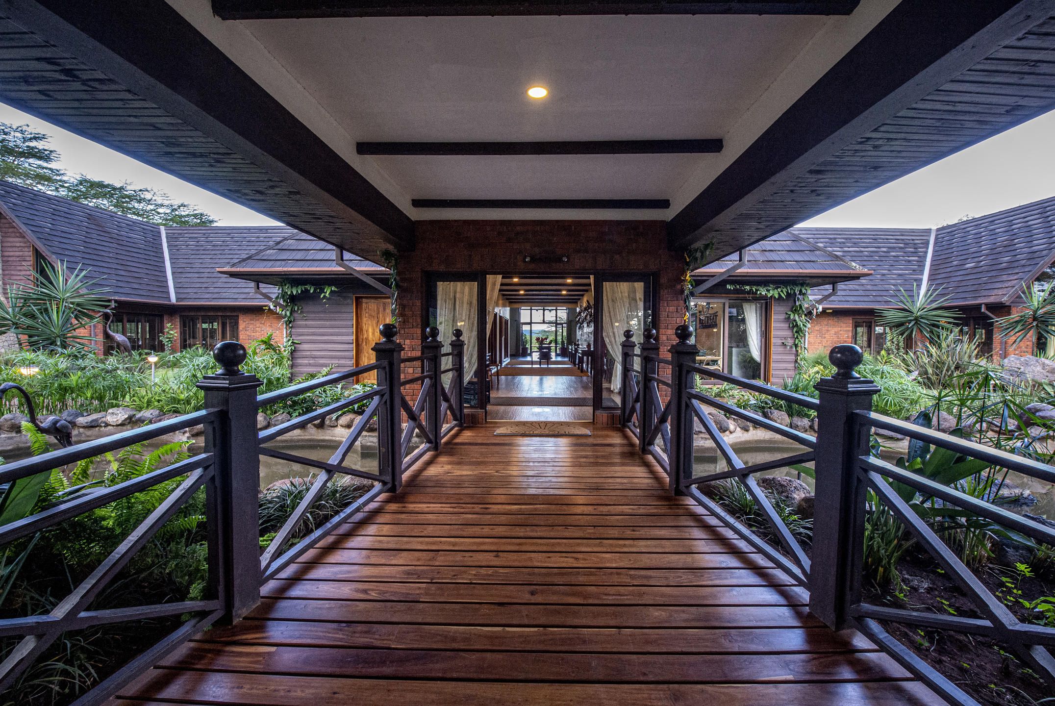 Wooden covered walkway leading to entrance of The Retreat at Ngorongoro