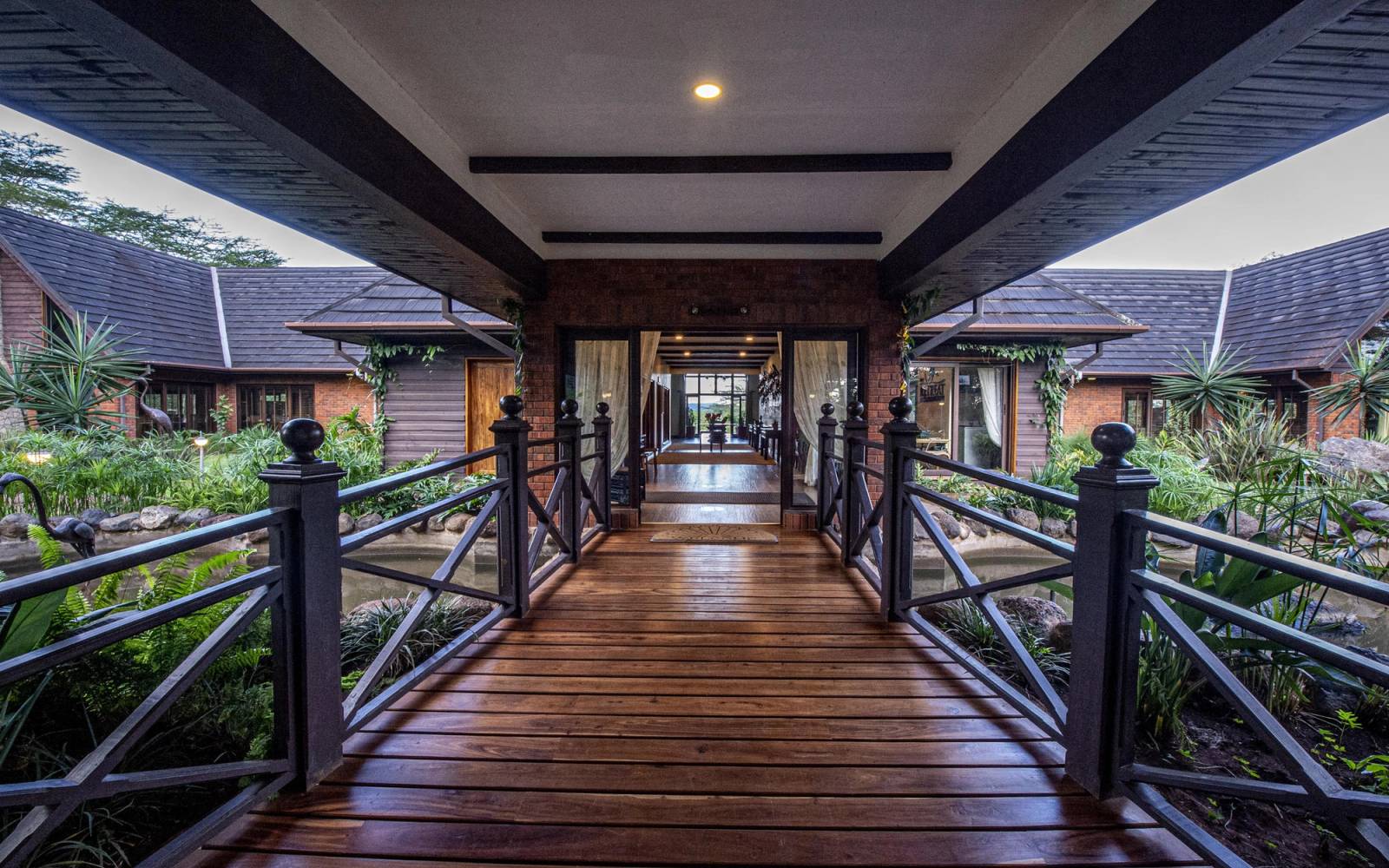 Wooden covered walkway leading to entrance of The Retreat at Ngorongoro