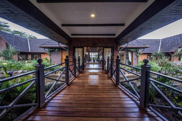 Wooden covered walkway entrance to The Retreat At Ngorongoro