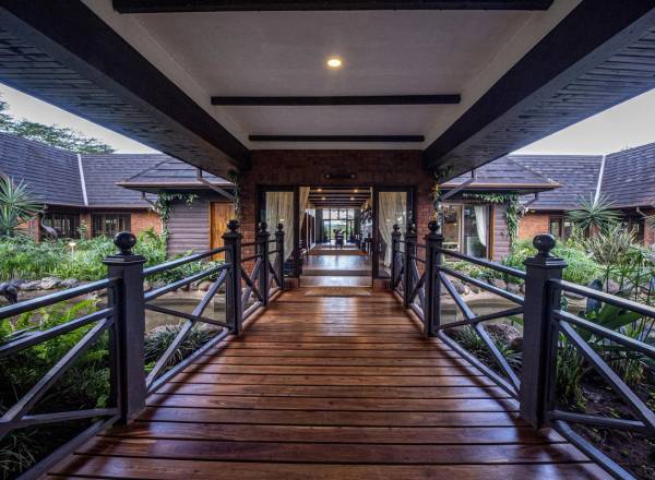 Wooden covered walkway leading to entrance of The Retreat at Ngorongoro