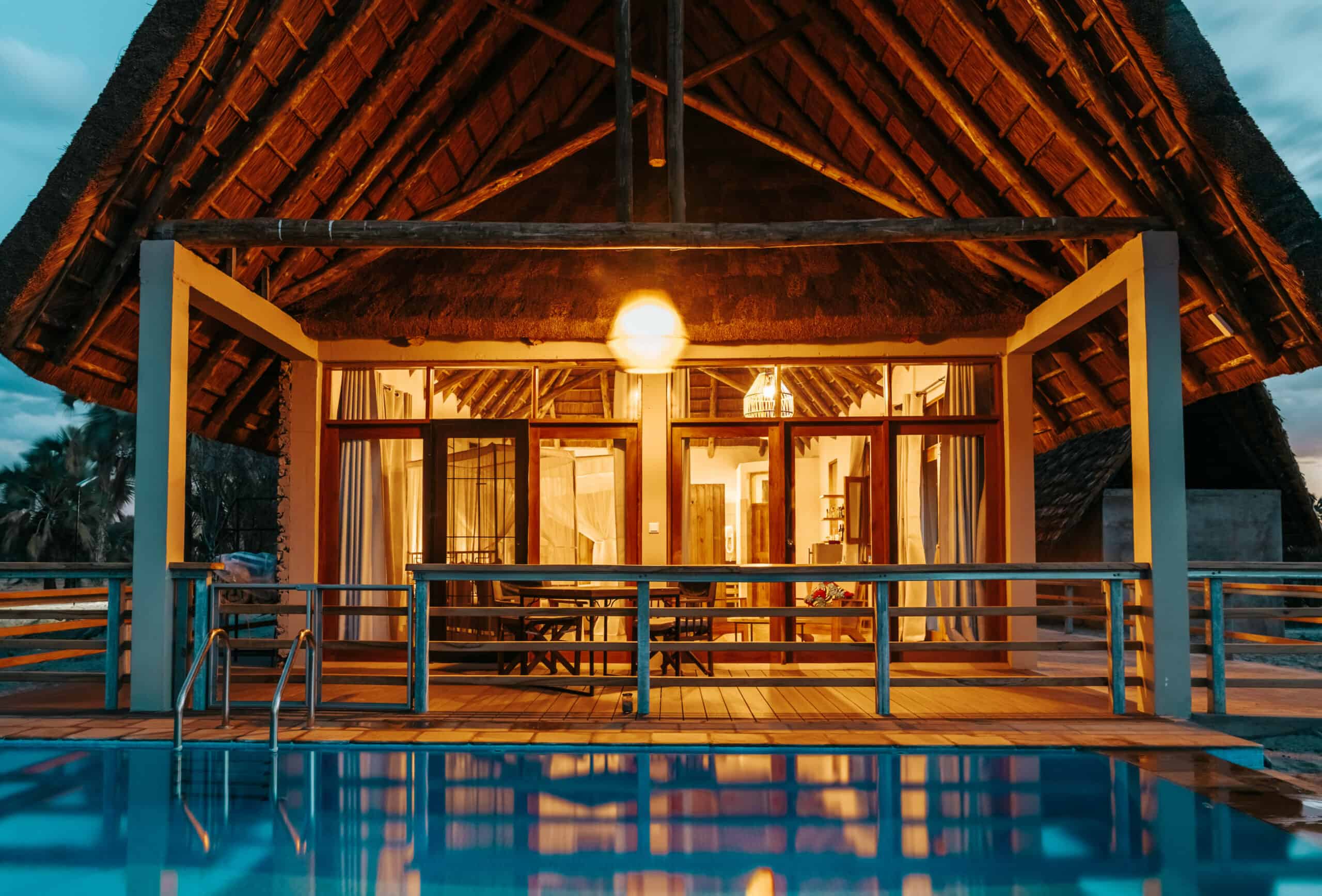 Thatched chalet with patio overlooking pool