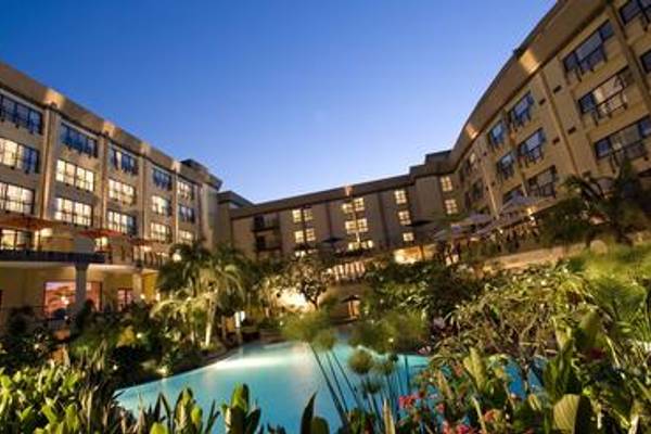 Large hotel courtyard with pool illuminated at night