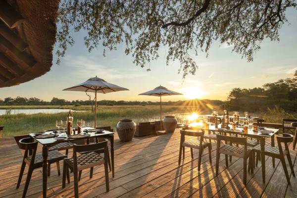 Sable Alley outdoor dining with sun setting over water and greenland