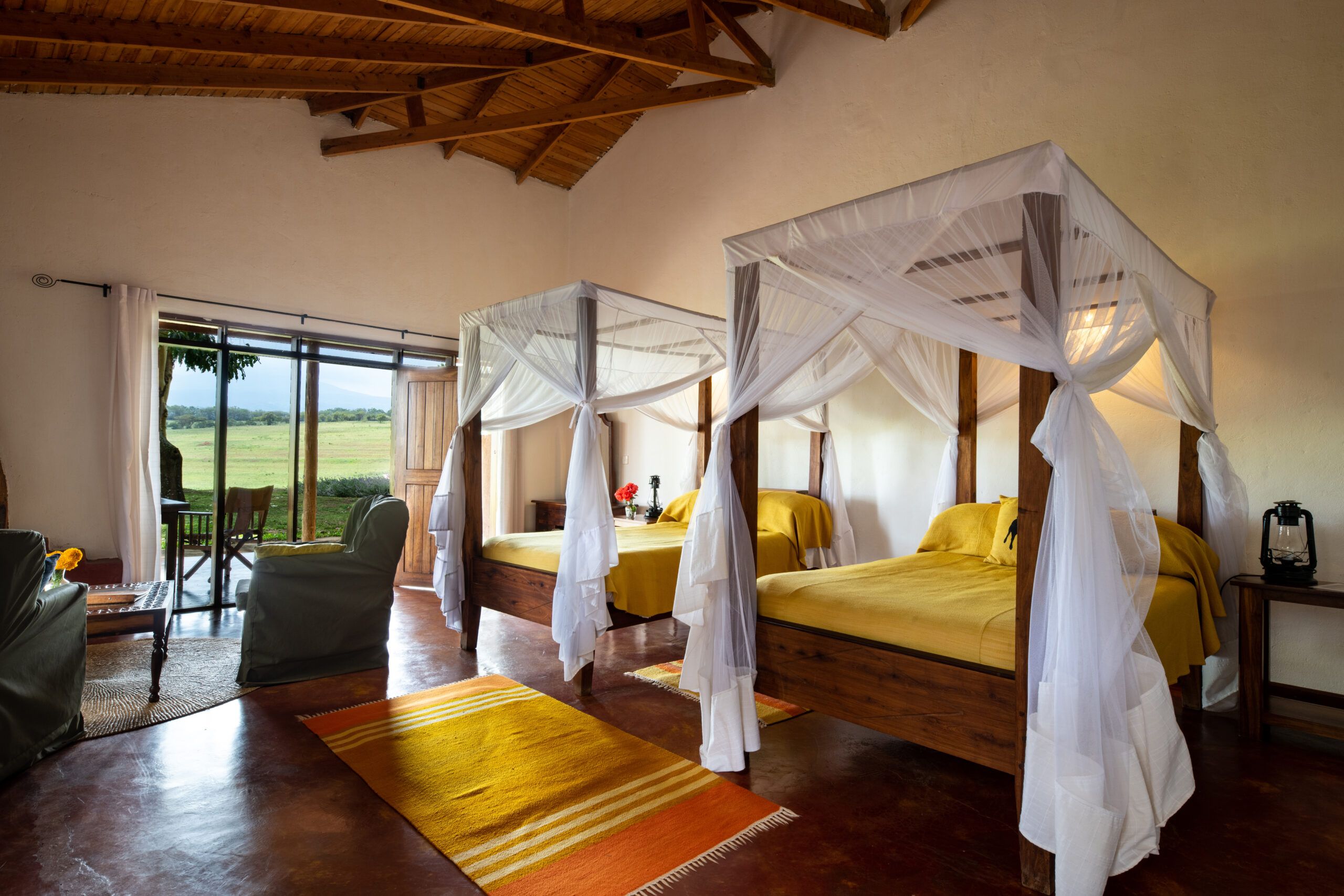 Two four poster double beds in Ngorongoro farm house suite