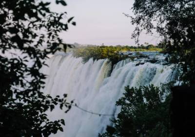 Victoria Falls waterfall framed by leaves