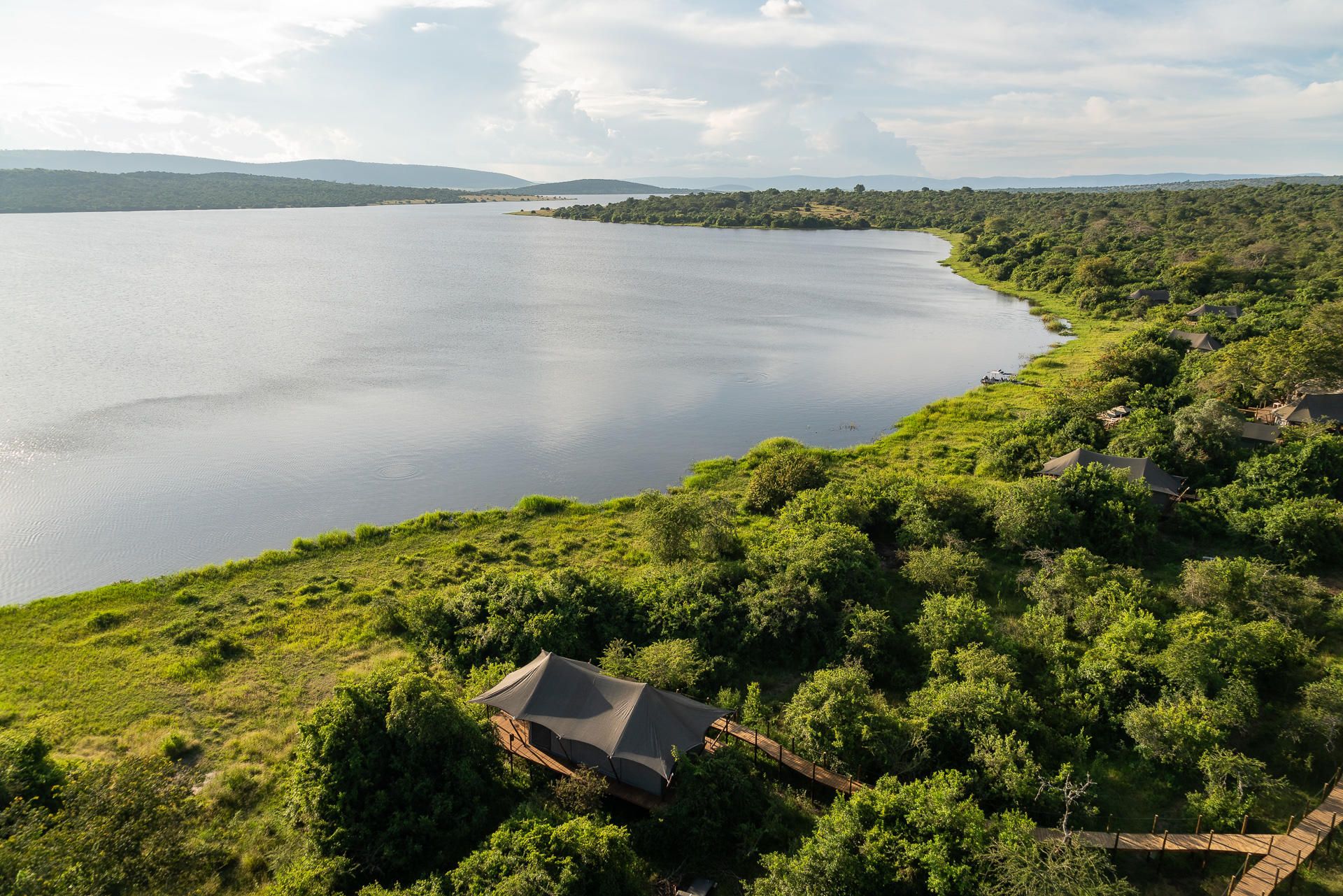 Aerial view of waters of Lake Rwanyakazinga and the Mutumba Mountains in the background and Wilderness Magashi Lodge in the foreground