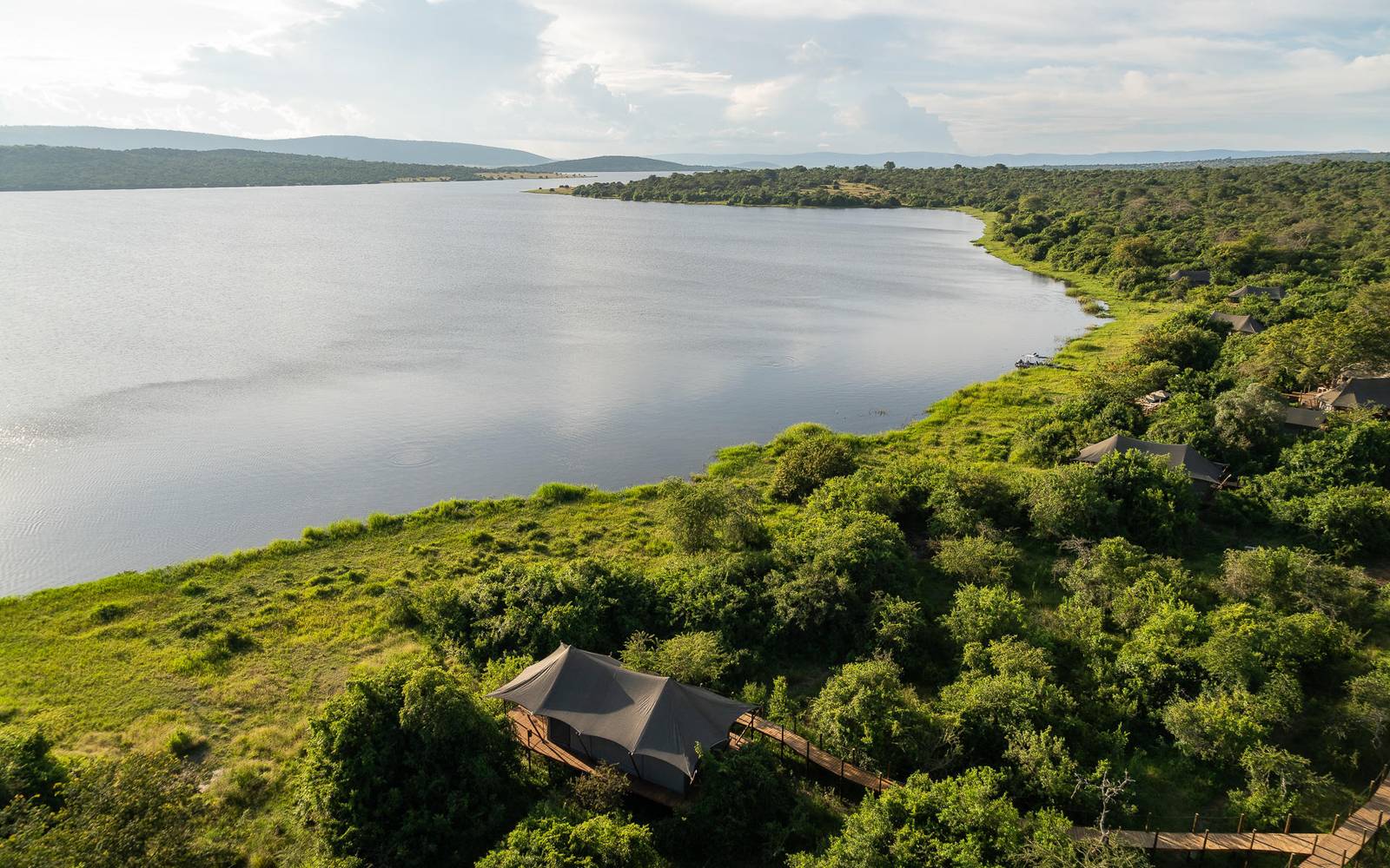 Aerial view of waters of Lake Rwanyakazinga and the Mutumba Mountains in the background and Wilderness Magashi Lodge in the foreground