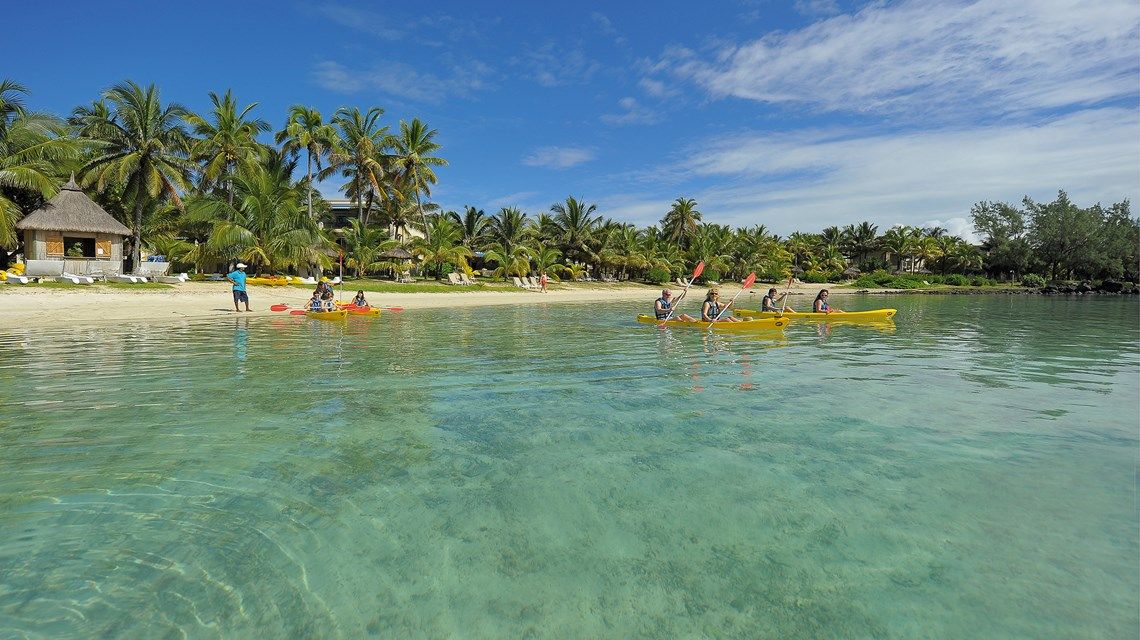 Guests kayaking in the turquoise waters off Shandrani Beachcomber Resort.