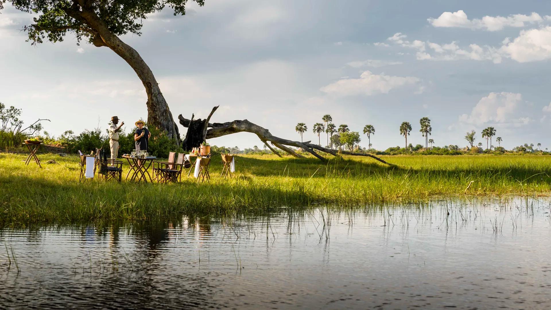 Two people chatting looking over Okavango Delta