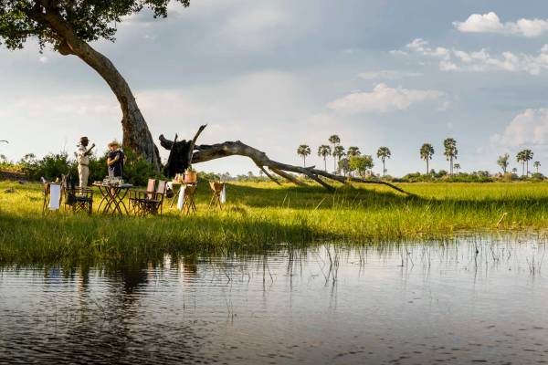 Two people chatting looking over Okavango Delta