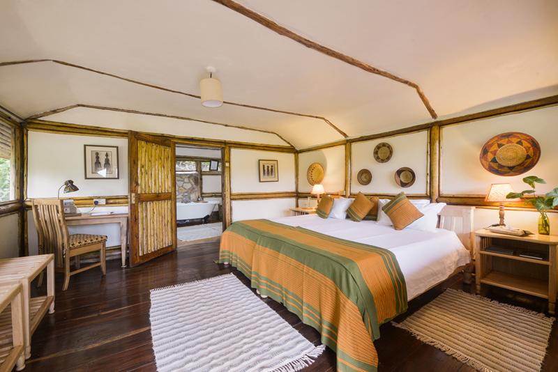 Double bedroom with wooden floors and beams