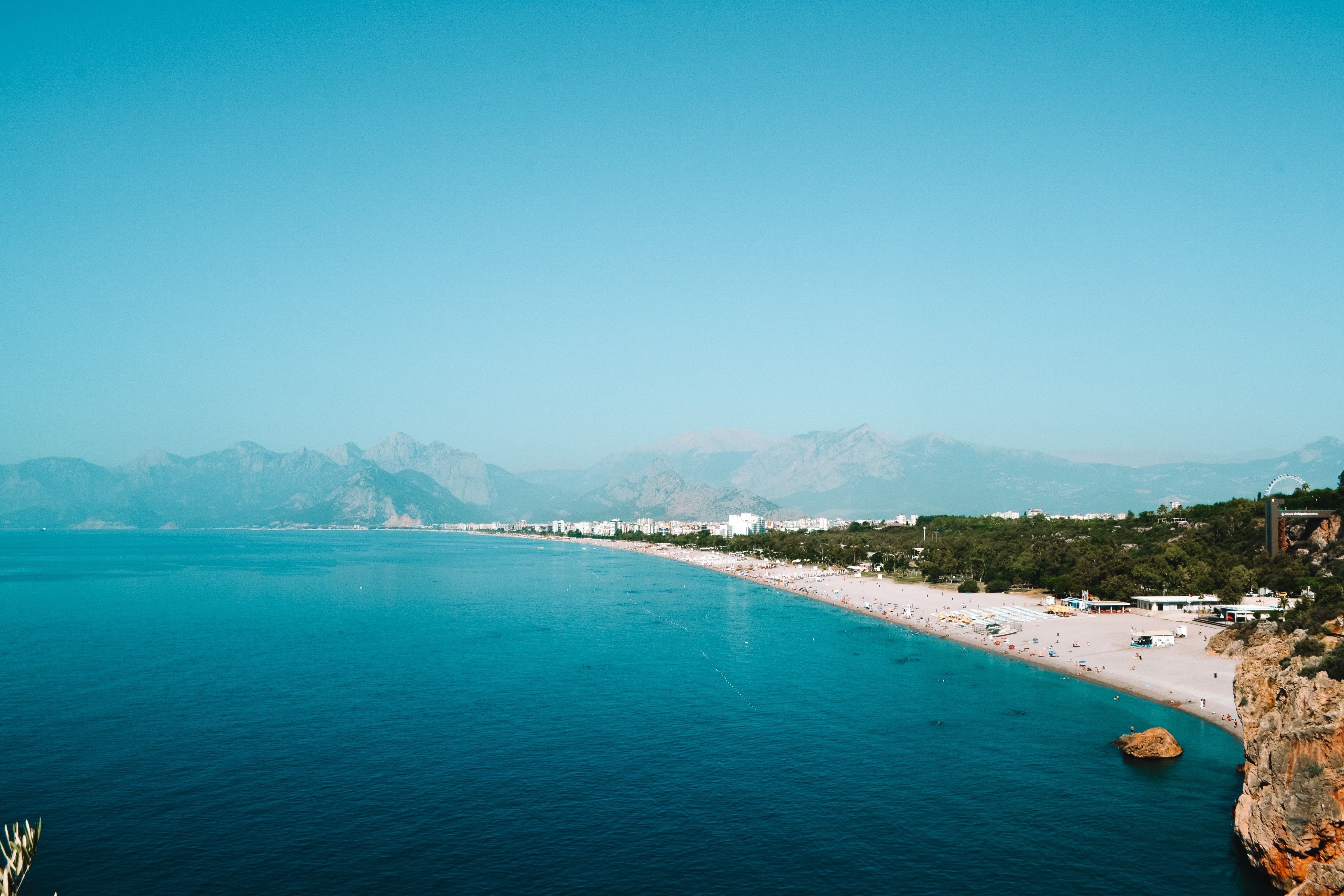A breathtaking aerial view of Konyaalti Beach with turquoise waters and distant mountains in Turkey