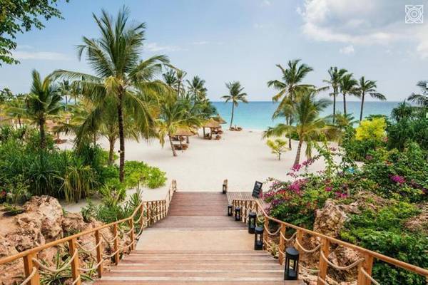 Zuri Zanzibar walkway down to palm tree adorned beach