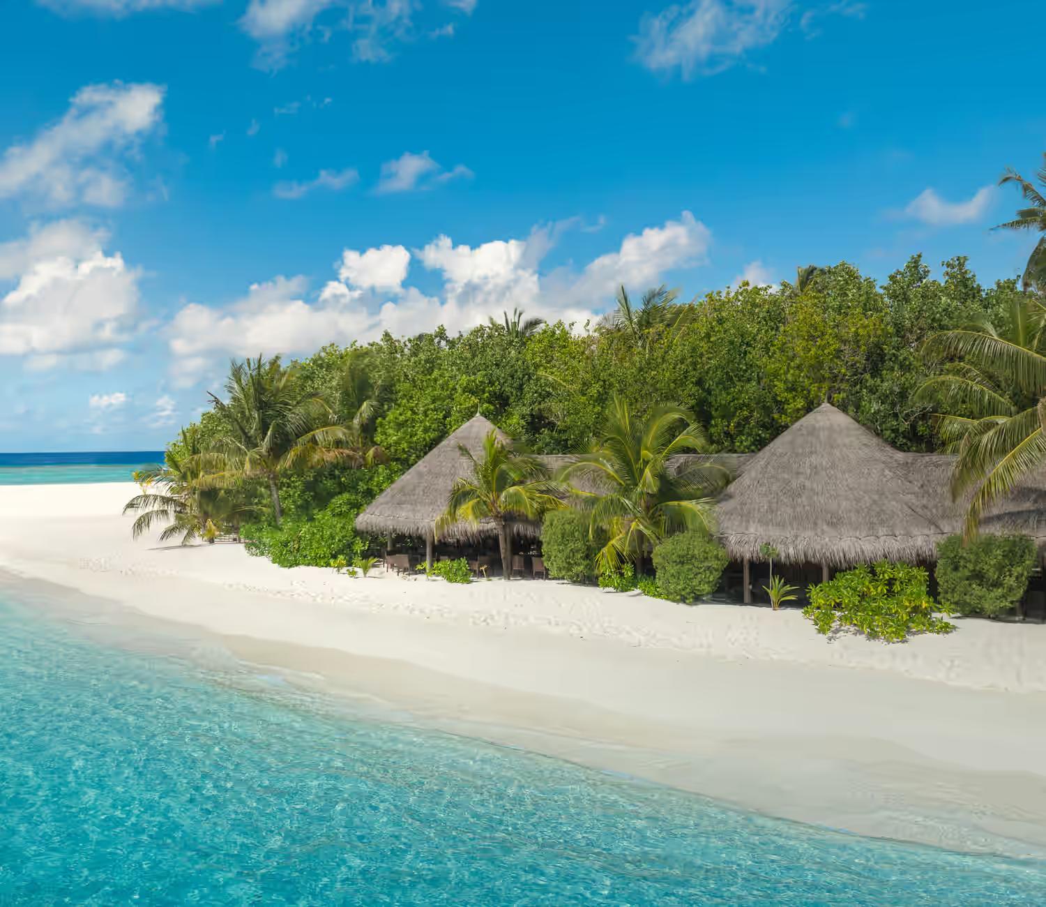 Adaaran Prestige Vadoo beach and blue waters with thatched chalets