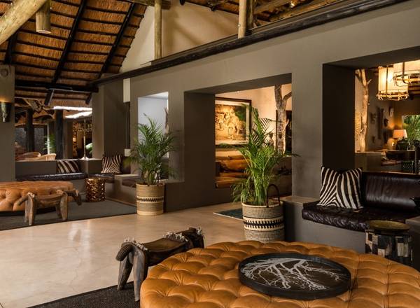 Sabi Sabi lounge interior with leather couches and African wooden instruments