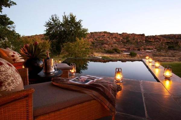 Bushmans Kloof infinity pool surrounded by lamps overlooking Cedarburg Mountains