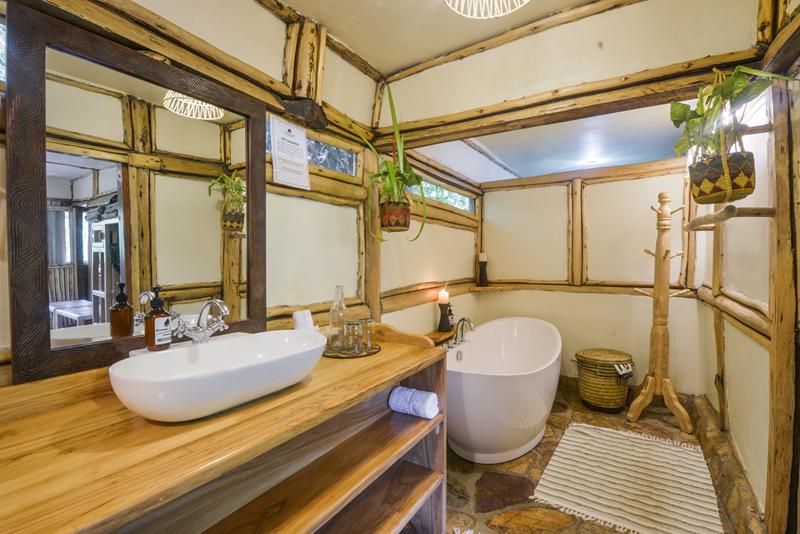 Bathroom with floating sink and large bucket bath