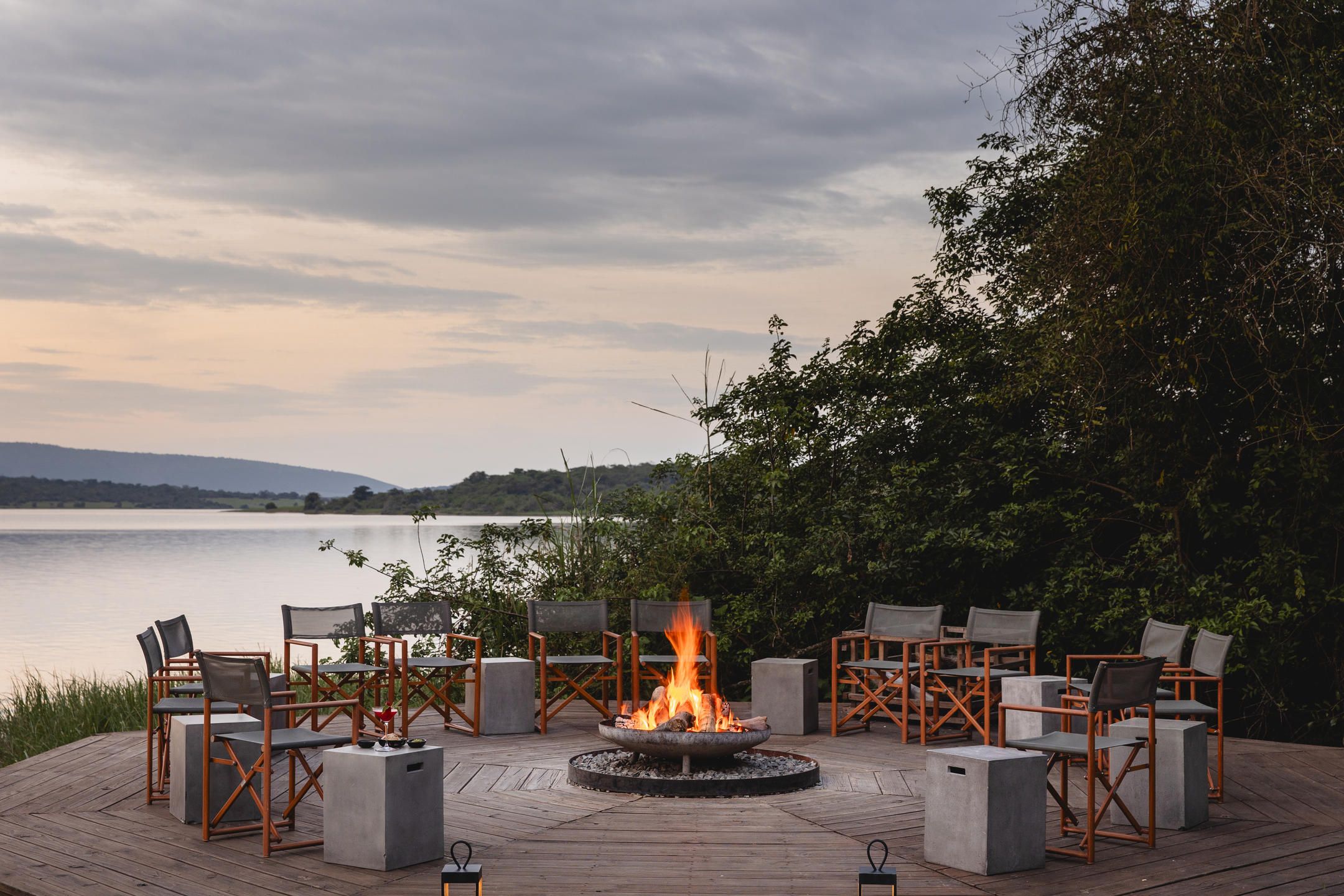 Fireplace with wood and canvas deck chairs surrounding in a circle