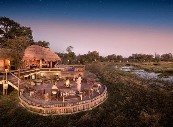 Sable Alley elevated lodge and fireplace area surrounded by lush landscape