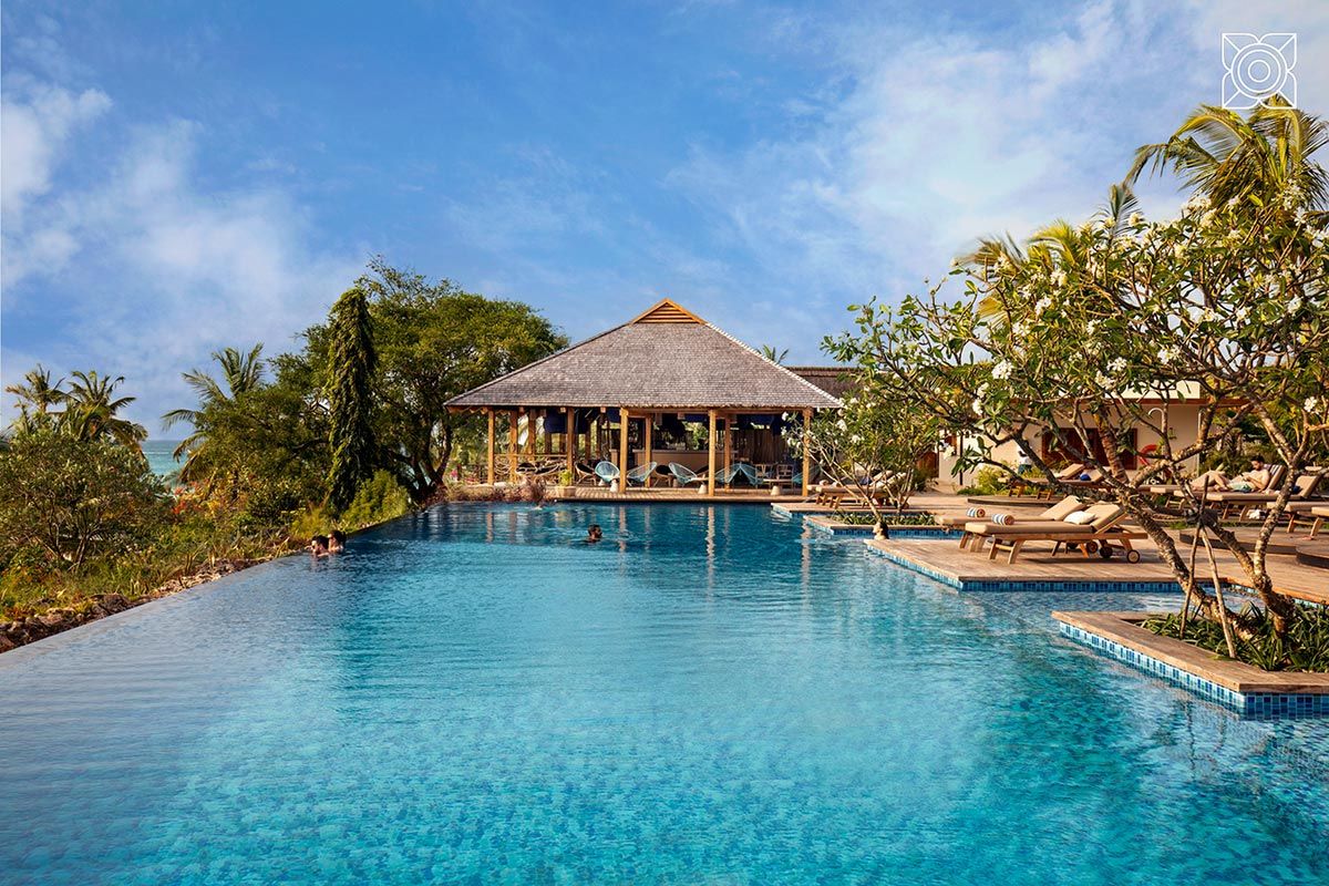 Zuri infinity pool with thatched chalet