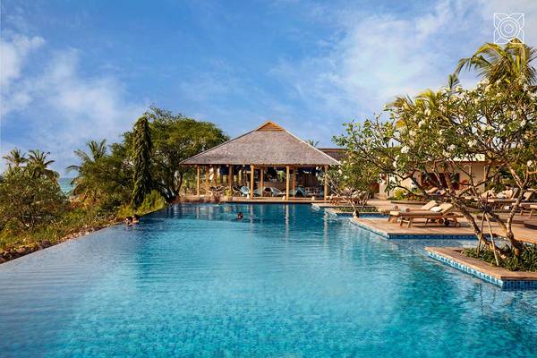 Zuri infinity pool with thatched chalet
