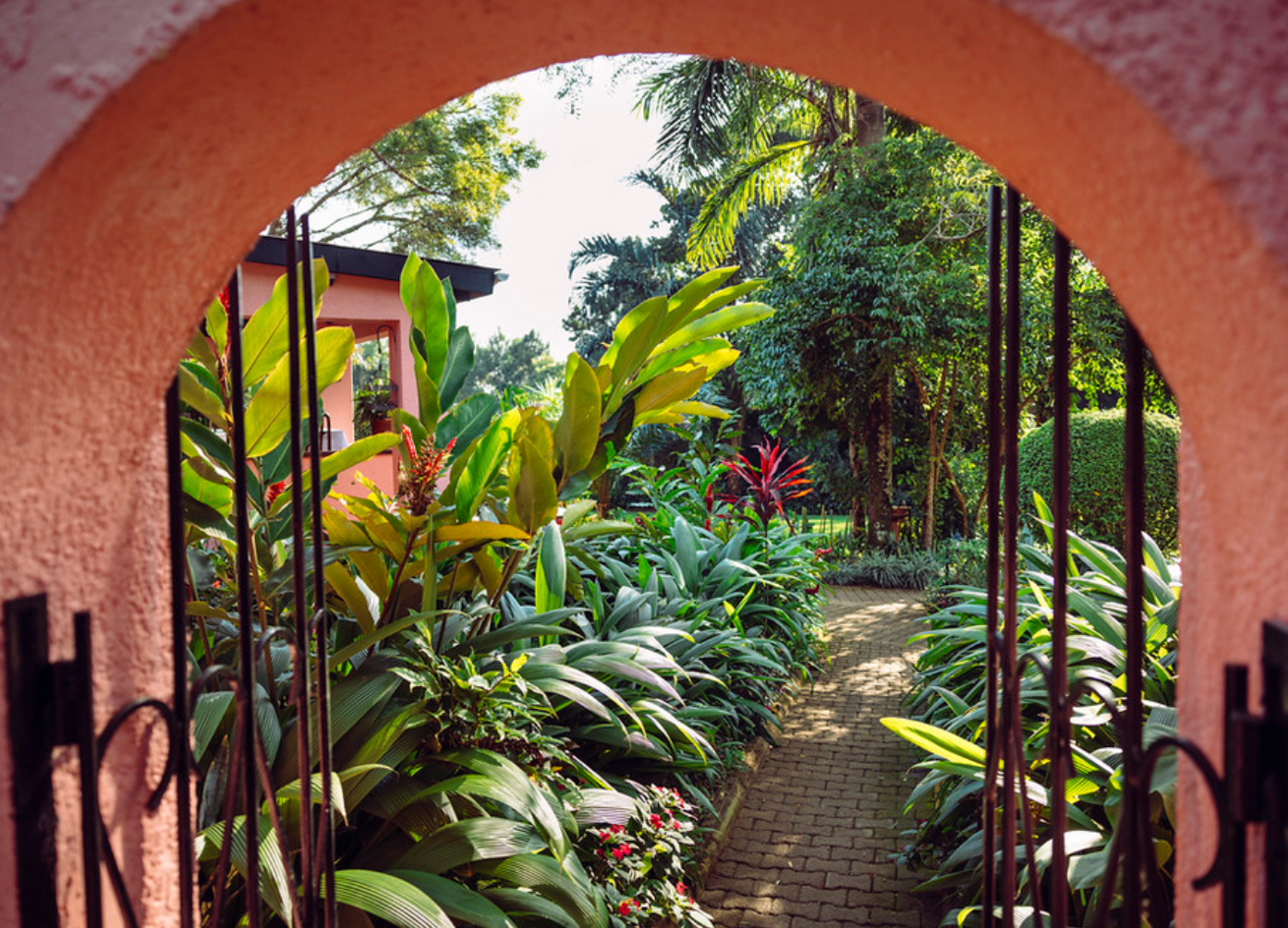 Archway into lush garden of Boma Hotel Entebbe