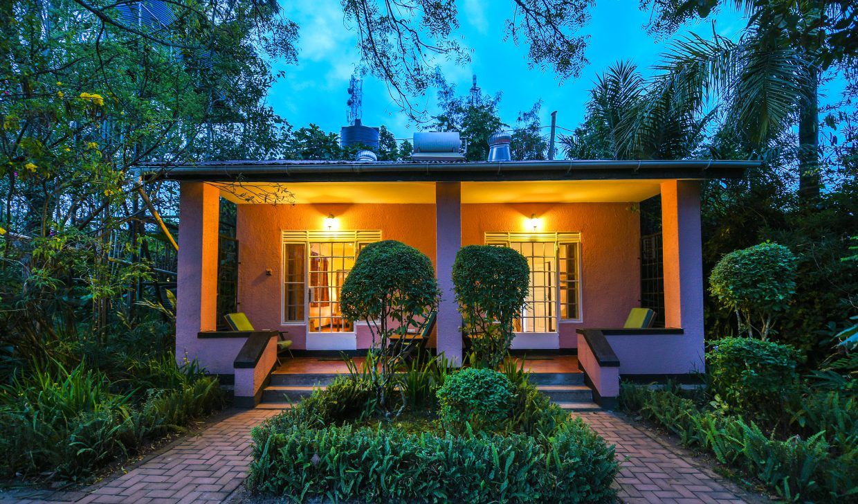 Exterior of cottage luxury suite with porch illuminated at night