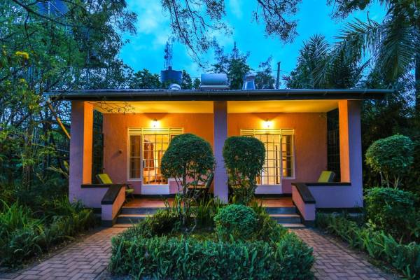 Exterior of cottage luxury suite with porch illuminated at night