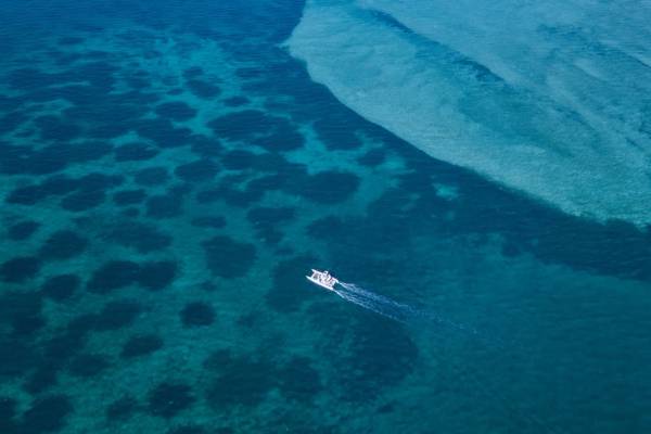 Aerial view of catamaran in bright blue waters of Bazaruto