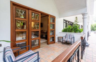 Veranda with two outdoor armchairs out side hotel bedroom