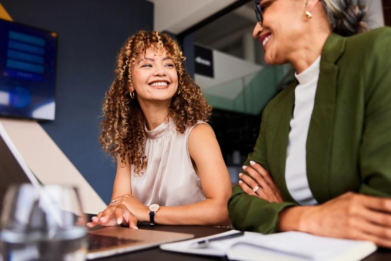 Two Women Discussing Travel Program