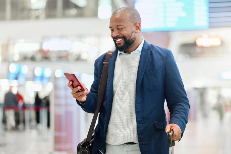 Man walking through airport on phone