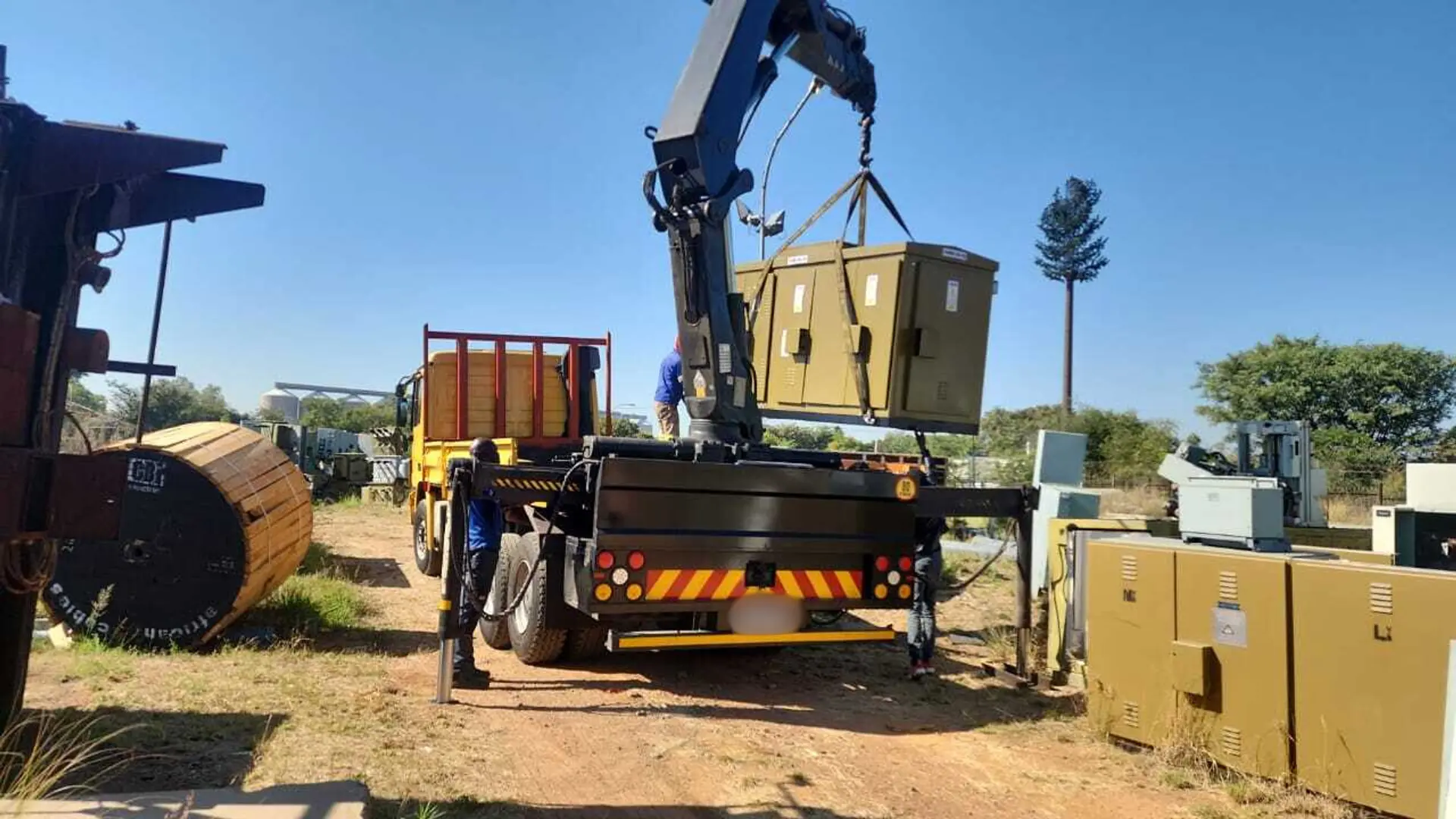 Crane lifting a transformer box