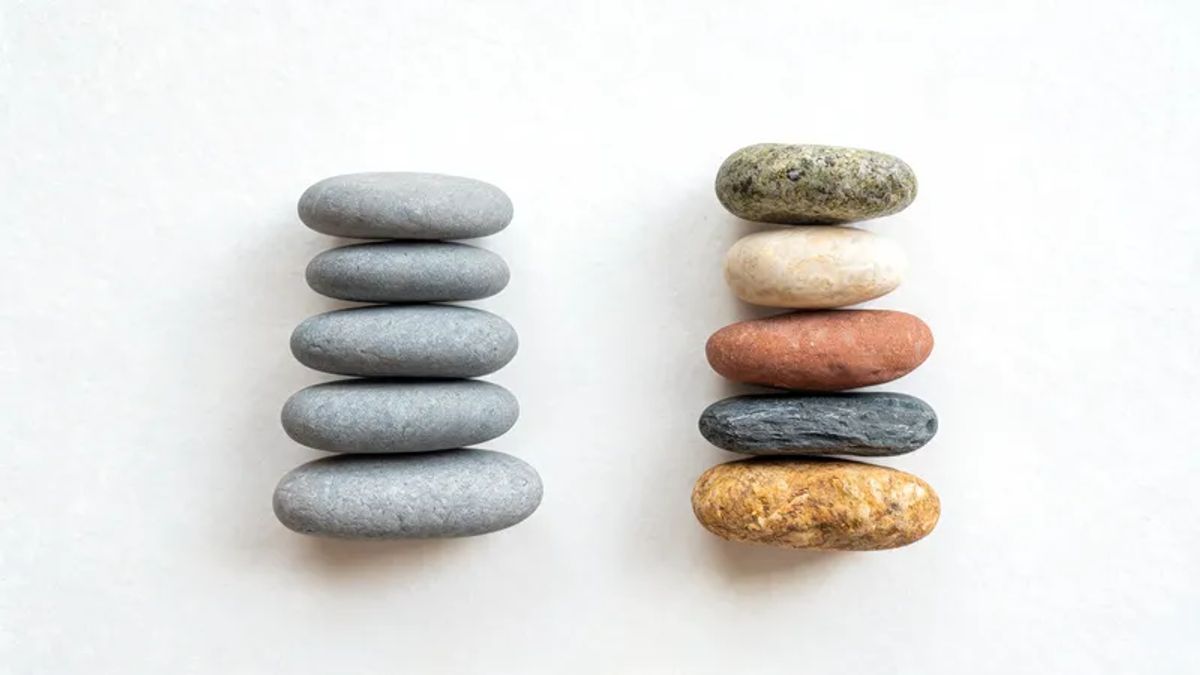 Two stacks of similar-but-different polished stones representing parallel feature axes between Character.AI and Janitor AI