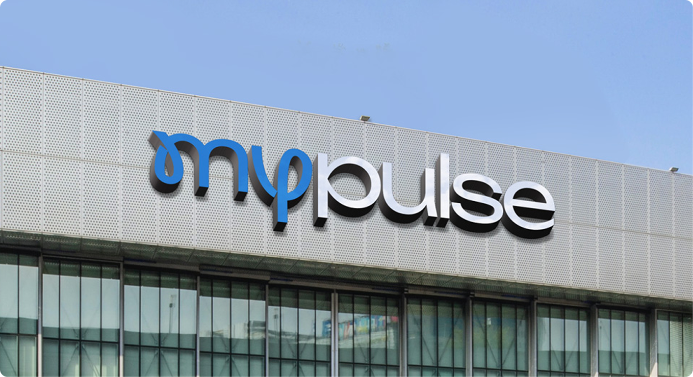 MyPulse wordmark as illuminated 3D signage on the facade of a fitness centre building