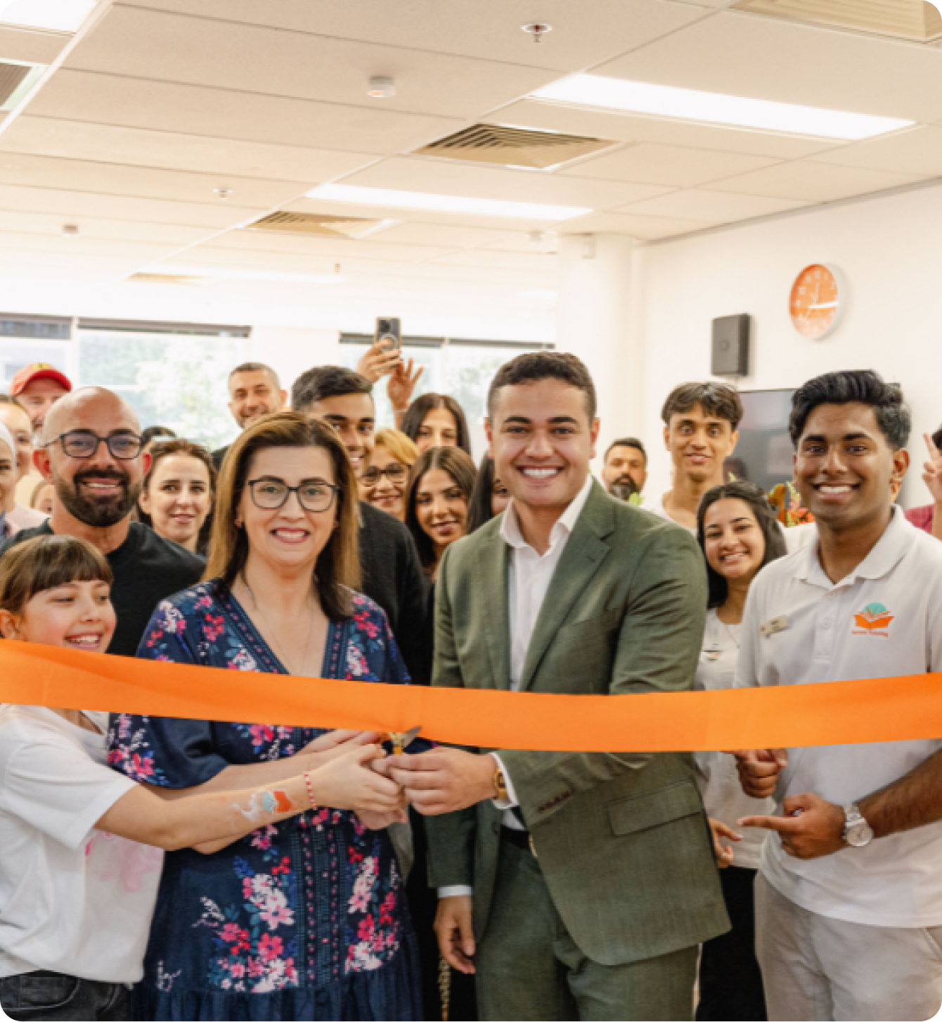 Franchise team celebrating a new centre launch with a ribbon-cutting ceremony