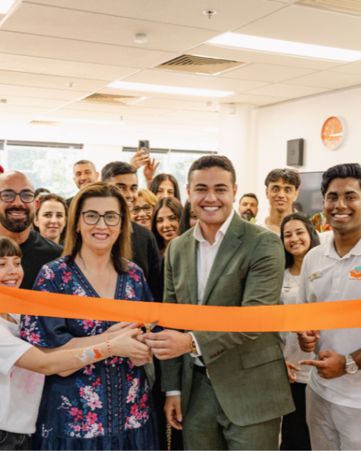 Franchise team celebrating a new centre launch with a ribbon-cutting ceremony