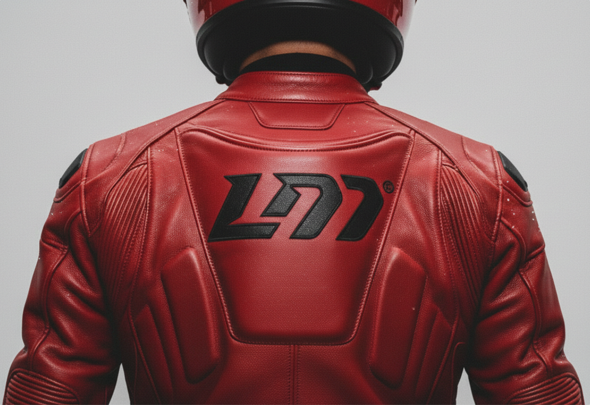 Rider in a red leather jacket with the LM logo embossed on the back