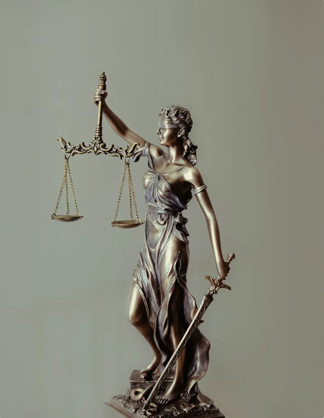 Bronze statue of Lady Justice holding her scales