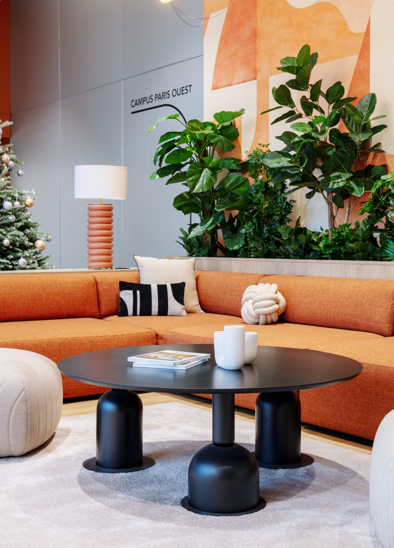 Orange sofa and round coffee table in a lounge fitted out by BMA