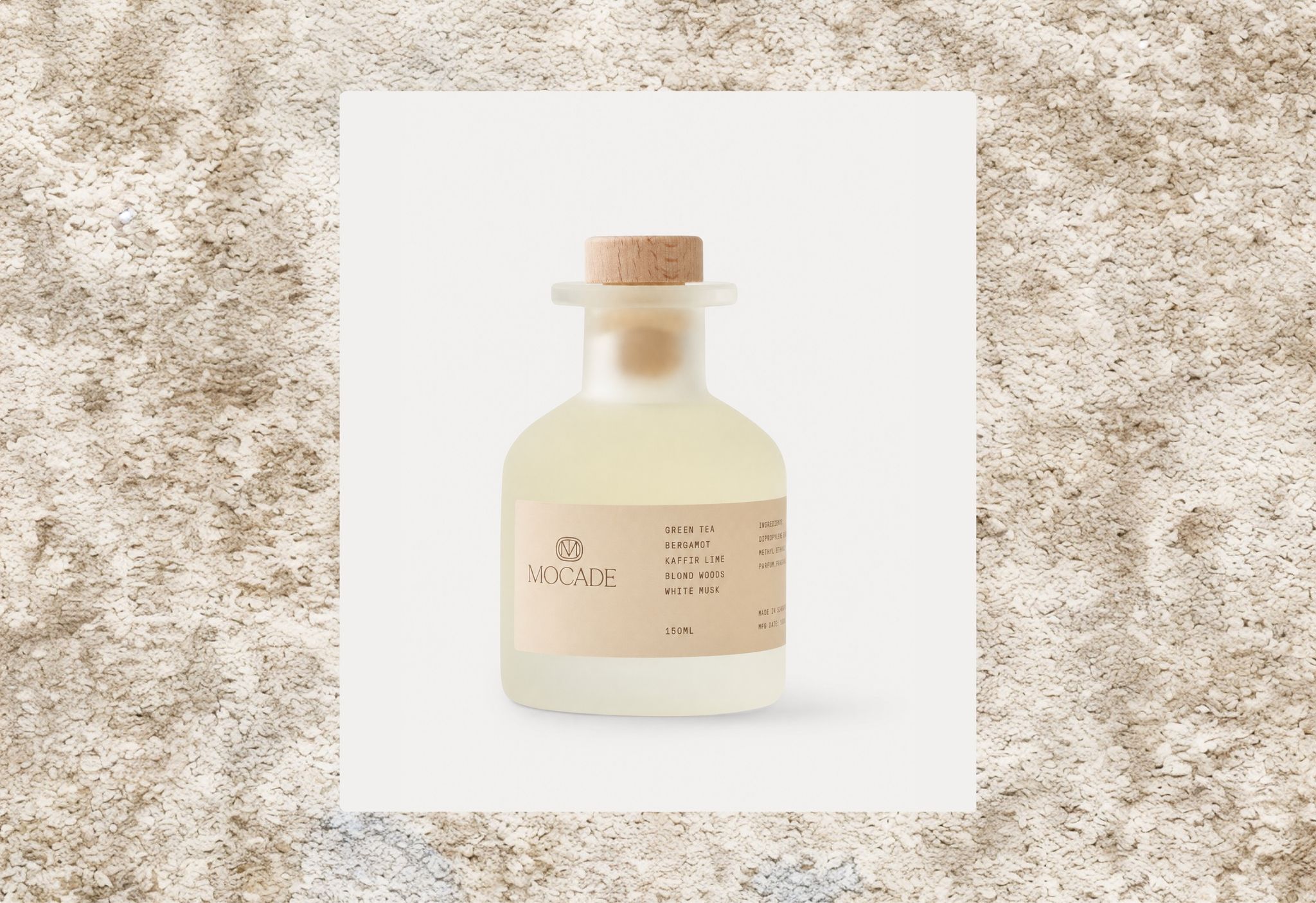 Mocade cleaning product bottle on a carpet texture
