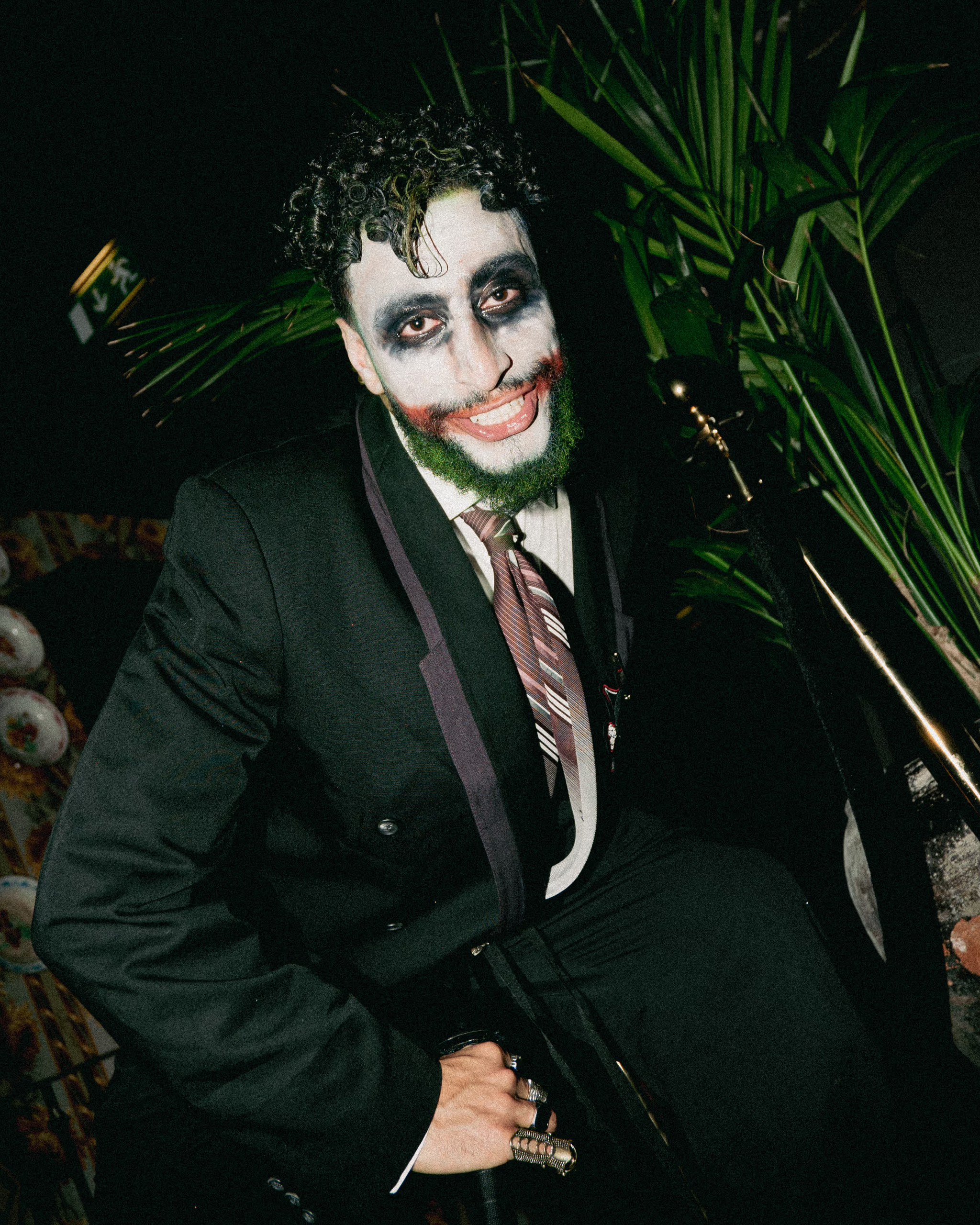 A guest in Joker make-up at a Sleeq party