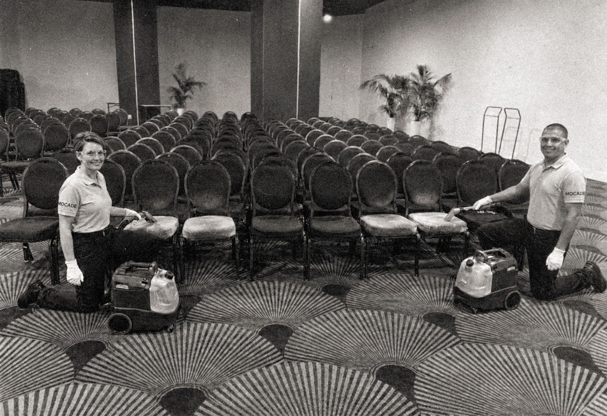 Mocade technicians cleaning the carpet of a conference room