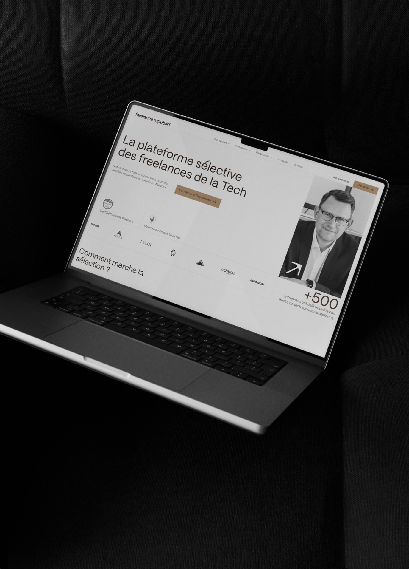 Laptop showing the Freelance Republik homepage on dark fabric