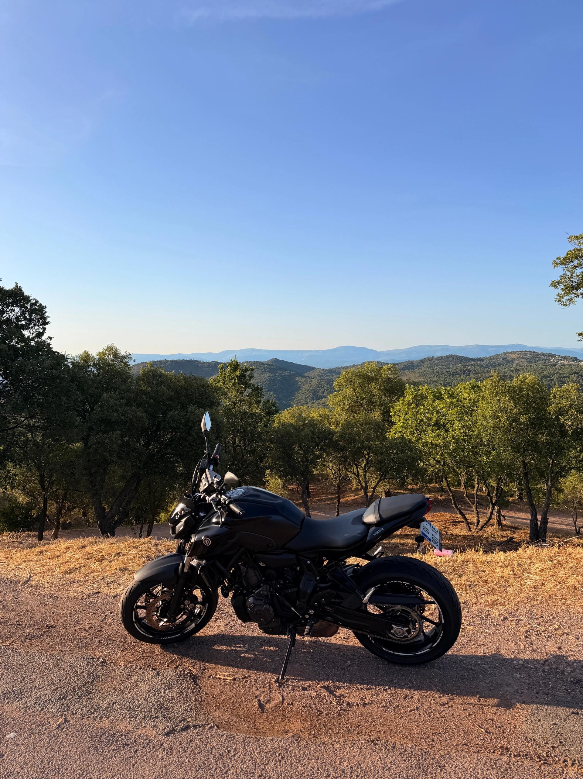 A motorbike parked above the valley