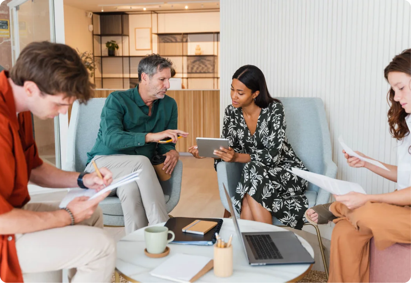 Four Qobra team members working together in a bright lounge