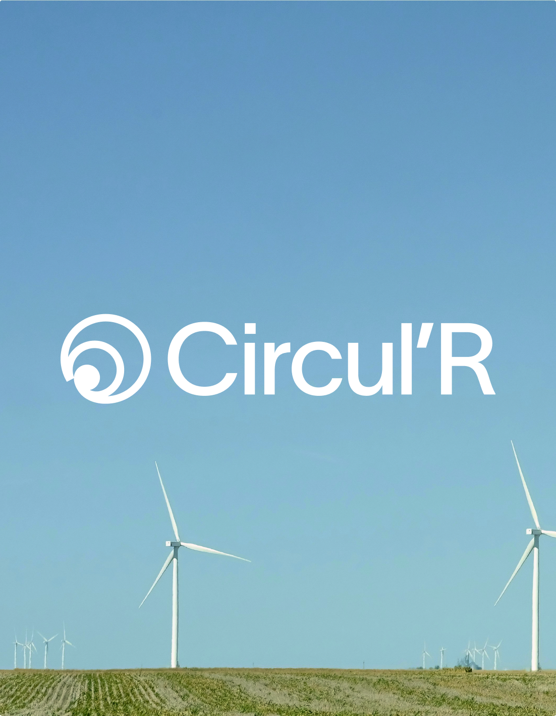 The white Circul’R logo over wind turbines in a field